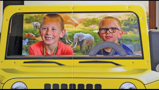 BRADYN MLENEK (L) and Owen Elvester got their photo taken in a Jeep during the VBS event at Faith Lutheran. 