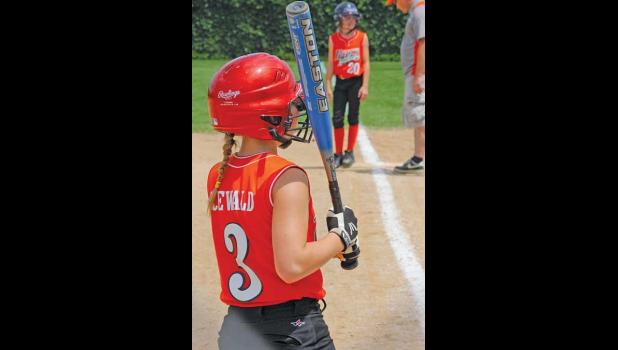 A BATTER FOR THE PRINCETON TIGERS SOFTBALL TEAM looked to the dugout to get signs from her coach during Saturday’s game in Becker.