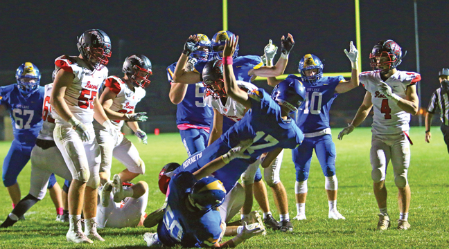 BIG LAKE QUARTERBACK BRANDON STERN (#17) falls backwards into the end zone after scoring Big Lake’s only TD last week against Rocori. (Submitted Photo).