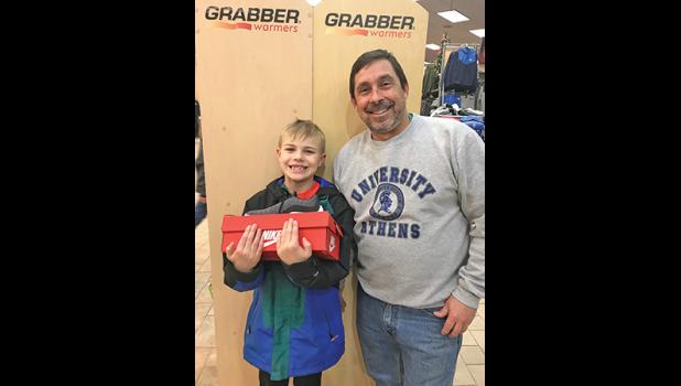 THIRD-GRADER VAUGHN BLAIR and PE teacher George Bienusa shopping at Scheels for Blair’s new shoes. (Submitted Photo)
