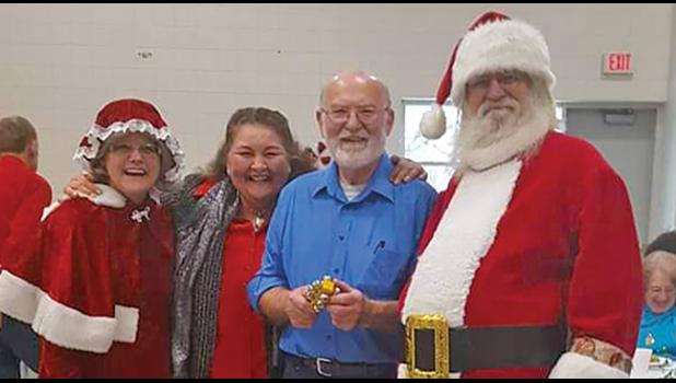 MR. AND MRS. CLAUS pictured with Carol Wida and John Riebel. (Submitted photo). 