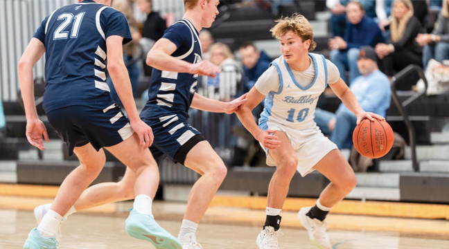 Becker’s Troy Nuest, pictured here in action versus Zimmerman, recently set the singe season steals record for the Bulldog boys basketball program.  Through just 19 games this season, Nuest has 69 steals (Photo Courtesy Ray Roberts). 