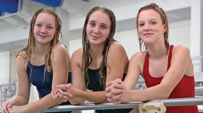 the bulldog divers are ready for the section meet.  Pictured are Lauren Woelfel, Sarah Woelfel and Bella Kuschel.  Not pictured is Karli Kirk. (submitted photo).