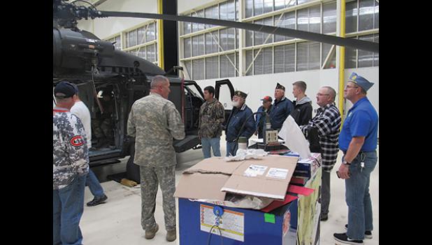 MEMBERS OF THE BECKER AMERICAN LEGION listen as facts on the Blackhawk helicopter are given. (Photo by Penny Leuthard)