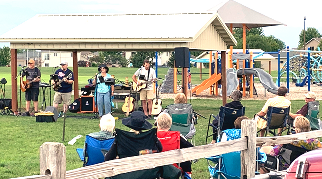  THE BAND ‘RETRO’ had the crowd’s toes tapping with their large variety of genres during one of the August Music in the Park concerts. (Photo by Penny Leuthard.)