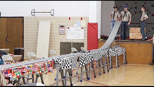 CUB SCOUTS race their derby cars at the recent Pinewood Derby, where a number of speed records were broken this year. (Submitted Photo)