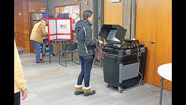 JACKLYN LIVINGSTON OF BECKER cast her vote Tuesday at city hall. Election judges said there had been a steady stream of voters all day, leading to a fantastic voter turnout. (Photos by Bill Morgan).