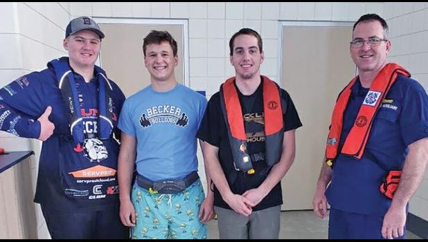 FULLY VESTED. (L-R) Charlie Wright, Carter Hietala, Jacob Novak with Coast Guard Auxiliary Jerry Stockham.