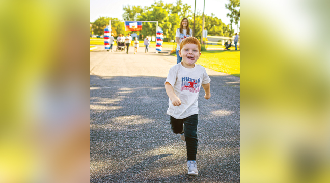THREE-YEAR-OLD Luke Bucher was full of joy in his jaunt through the course. (Submitted Photo).