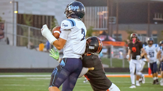 BECKER WR SAWYER BROWN leapt to make this catch against a St. Cloud Tech defender last Friday in Becker’s win over the Tigers, 21-0. (Submitted Photo by Anne Koste).