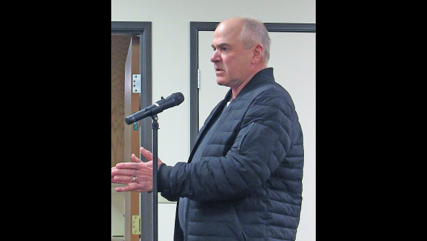 HANK FOEHRENBACHER explains how the defibrillator located at his Sherwood Shores West neighborhood property has been installed. (Photo by Penny Leuthard).