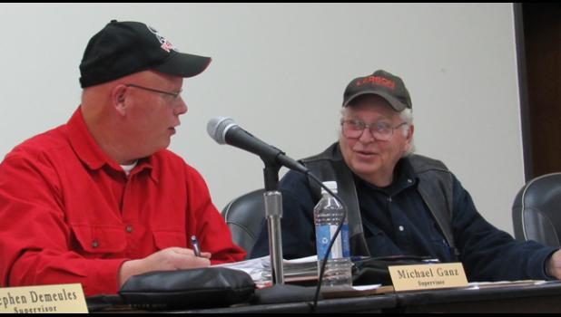 PALMER TWP. SUPERVISORS Mike Ganz and Richard Larson talk about snow being pushed across roads in the township Monday night. (Photo by Penny Leuthard) 