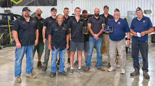 BUD STIMMLER AND STEVE SCHRADER of the Clear Lake American Legion (R), presented a plaque to employees of Guardian Fleet Safety this past summer for their participation in hiring Veterans at their place of business. Front row, from left to right: Josh Casey, Rick Gehrke, Derek Brittan, Charles Teigen, Steve Schrader and Bud Stimmler. Back row, left to right: Josh Vander hayden, Austin Ward, Mitchell Anderson, John Knoebel and Kyle Pundsack. (Submitted Photo).