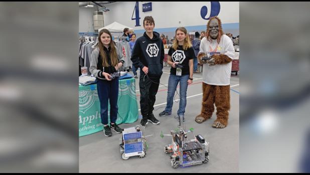COMMUNITY OUTREACH is an important component of the Robotics team’s mission; last Saturday they attended the Becker Business Expo to answer questions and show the community what they’re all about. At right, honorary team member Sassy from the Citizen-Tribune. (Photo by Penny Leuthard)