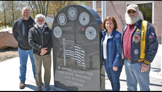 Al Scherping, Mike McDowell, Mayor Tracy Bertram and Roger Bigalke posed alongside the black marble monument outside Becker City Hall last Friday afternoon. (Submitted Photos).