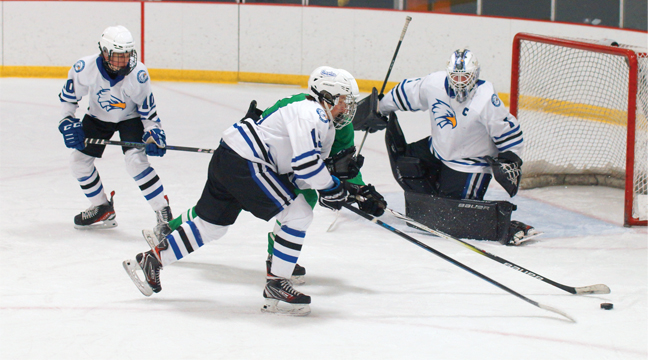 EAGLE DEFENDERS fought for the loose puck against Pine City as Becker/Big Lake’s goalie secured the crease. (Submitted Photo).