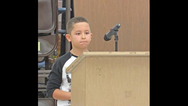 SPELLING BEE CHAMPION ELIJAH S. concentrates during the final round of the competition last week. (Photo by Penny Leuthard)