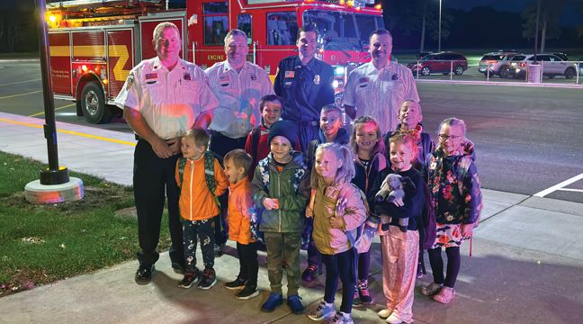 Children posed with Firefighters as they arrived at school. (Patriot Photo by Don Bellach)