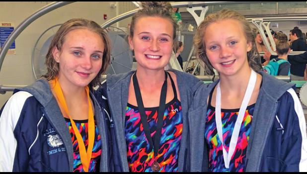 SARAH WOELFEL, Keeley Holm and Lauren Woelfel brought home medals from the recent True Team meet. (Submitted Photo).