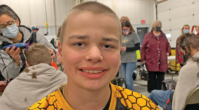 ONE OF COLTON’S TEAMMATES on the football team, Jackson Laroche, was all smiles as he got his head shaved by his mother, Jessica (not shown). (Patriot Photo by Bill Morgan)