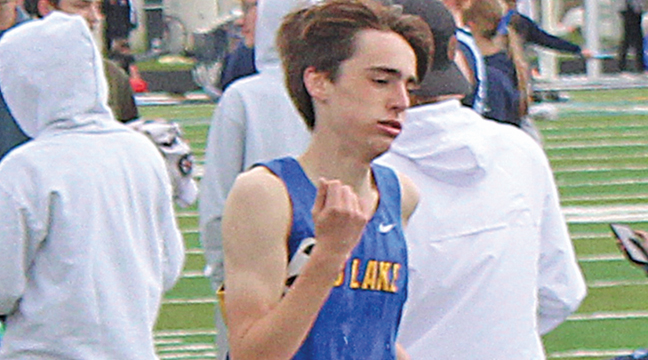 Jack Leuer starts his kick on the last lap of the 1600. He won in a time of 4:21.45. (Photo by Ken Francis)