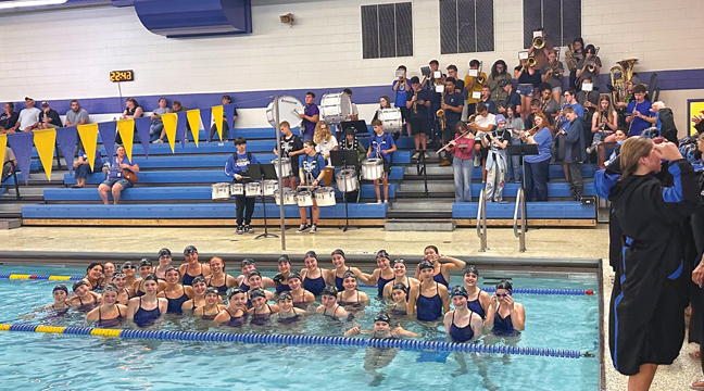 THE BIG LAKE SWIM/DIVE TEAM gathered in the pool while the pep band played the National Anthem and then had a moment of silence to commemorate 9/11. (Submitted Photo).
