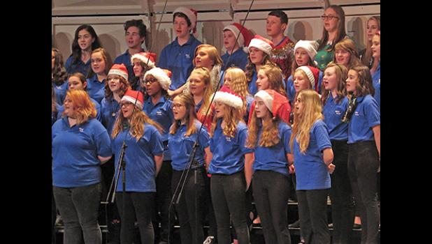 THE 8TH GRADE ENSEMBLE PERFORM It’s Beginning to Look a Lot Like Christmas, many in cheerful Santa hats. (Photo by Penny Leuthard)