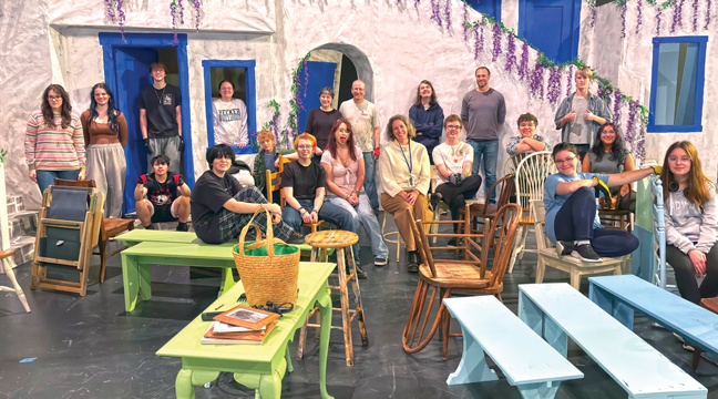 Director Penny Pingrey, Tech Director Curt Hed, Stage Mom Marie Hed, and Light Designer Seth Dutcher (in back) took a moment from their work to pose for a picture with the stage crew. (Patriot Photo by Don Bellach)