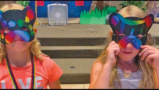 NATALIE MCCORMACK (L) and Audrey Meyer wore animal masks during their VBS experience. (Submitted Photos)