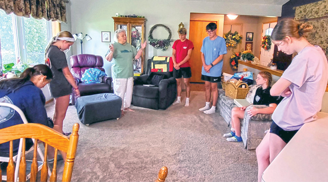 Great River Faith in Action  loves coordinating projects for senior citizens in our community that need some help living safely in their homes. Above, volunteers gather to pray. (Submitted Photo.)