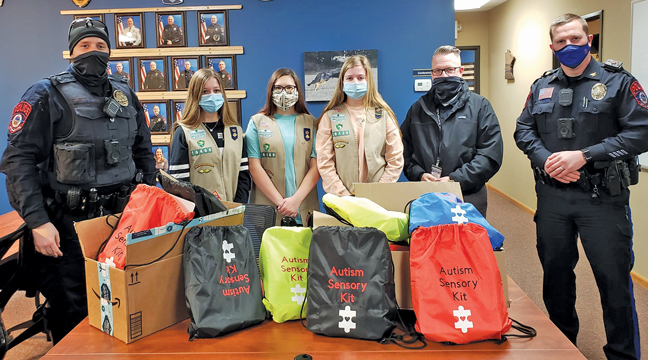 THE GIRL SCOUTS TROOP 16466 donated Autism Sensory Bags to the BLPD. From left to right is Investigator Nic Prigge, Cailyn, Ruby, Brynn, Investigator Rich Berg, and Deputy Chief Matt Hayen. (Submitted photo.)