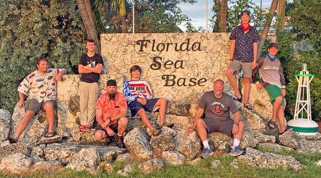 THE SCOUTS GATHERED AROUND THE FLORIDA SEABASE SIGN.  From left to right:  Christopher Kardell, Jakob Johnson, Josh Whaley, Jacob Scherping, Al Scherping, Hunter Whaley and Ben Scherping. (Submitted Photo).