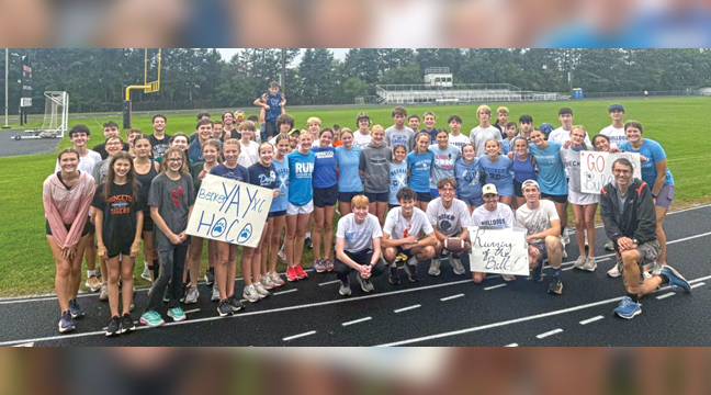 Both the Becker Boys and Girls cross country teamS posed for a photo before running the homecoming football to Eppard Field last Friday. (Submitted Photo).