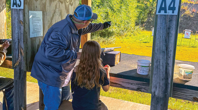 A Get Youth Outdoors Day volunteer assists a youth shooter on the range on Sunday, Sept. 8 at Wild Marsh Sporting Clays. Many participants experienced shooting a gun or hitting a clay target for the first time. (Submitted Photo).