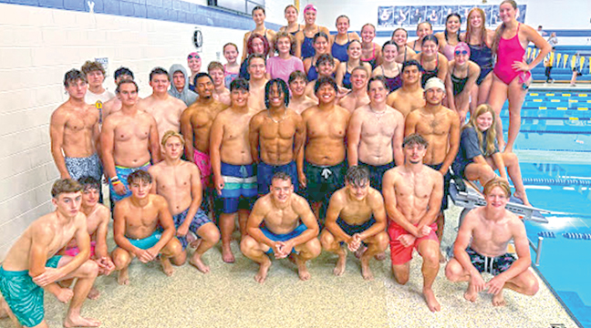 THE BIG LAKE GIRLS SWIM/DIVE TEAM gathered with the football team’s participants for a cure for cancer event last Saturday. (Submitted Photo).