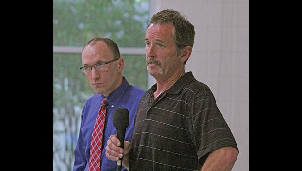 SCOTT HELBERG OF NMR and City Administrator Greg Pruszinske (background) answered questions from the crowd during last June’s open house. (Photo by Bill Morgan).