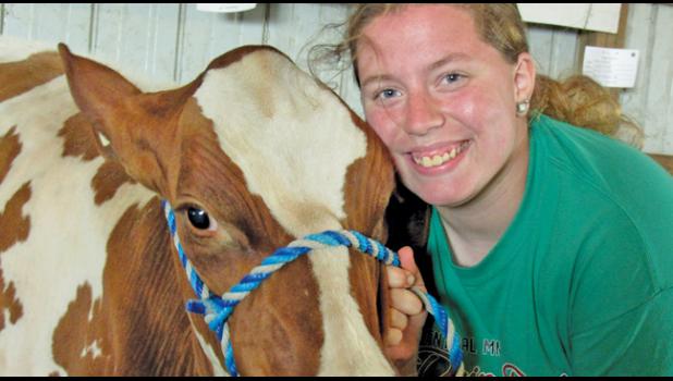 KIEYA SARGENT, who belongs to the Maple Lake 4-H club and attends Annandale HS, won junior champion with her Ayrshire and Holstein crossbreed at the Wright Co. Fair.