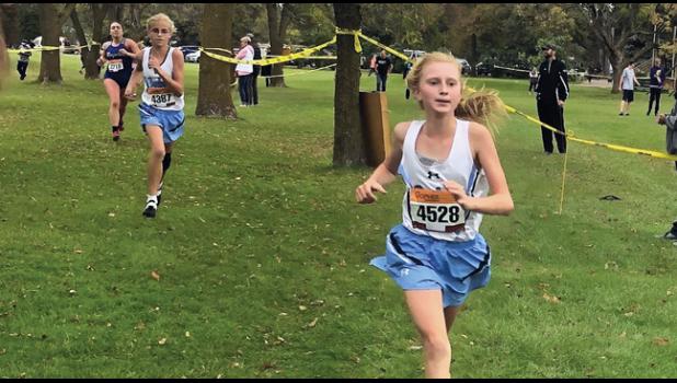 NATASHA BERTHIAUME pushes hard during Thursday’s Buffalo Invitational, finishing as one of two of the Bulldogs top place runners. (Submitted Photo)