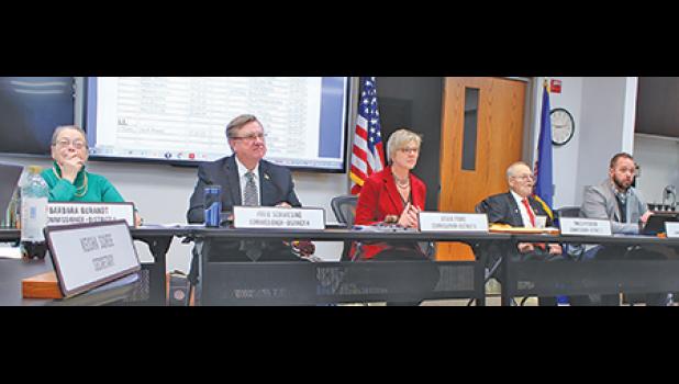 The Sherburne County Board approved salary increases for elected officials and for themselves at Tuesday's meeting. (From left) Commissioners Barbara Burandt, Felix Schmiesing, Lisa Fobbe, Ewald Petersen and Tim Dolan. It was Petersen's last meeting as a commissioner. Raeanne Danielowski will be sworn in at the January 8 meeting. (Photo by Ken Francis.)