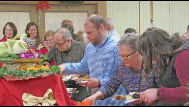 GUESTS AT CAMP FRIENDSHIP’S HOLIDAY PARTY enjoyed a large array of delicious hors ‘d oeuvres and tasty treats. (Photo by Penny Leuthard)
