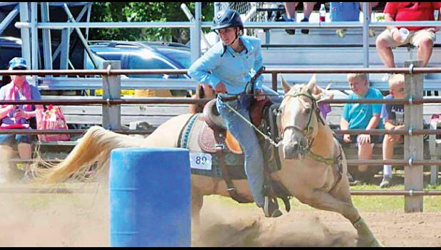 BARREL RACING. Grace Kampa, a Becker High School student and member of Shooting Stars 4-H club of Clear Lake is pictured barrel racing at Benton  County Fair last week. Grace has been in 4-H  since 3rd grade and has been riding horse  since she was 18 months old!  (Submitted photo). 