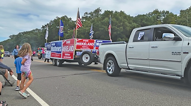 THE SHANE MEKELAND/ANDREW MATHEWS FLOAT was full of patriotism elements as the political figures handed out treats for the parade watchers.(Patriot Photo by Carol Hanson).