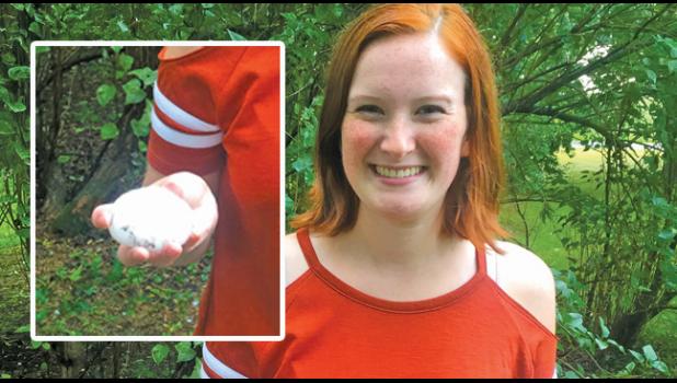 HUMUNGOUS HAIL. Maria Sakry (of Santiago area), displays a humungous piece of hail at her grandmother Terese Weis’ home on Co. Rd. 20 north of Co. Rd. 16. The Weis family was celebrating Terese’s 92nd birthday and needed to stay inside until the inclement weather passed. (Submitted Photo)