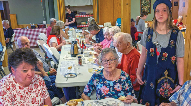 Glendorado Lutheran Church served 216 meals at their annual Norwegian Syttende Mai Dinner day the end of May. On the menu was ham, meatballs, Flote Grote, pickled herring, scalloped potatoes, fruit Salad, Norwegian baked treats and more. There was also a craft sale at the popular annual event. Pictured is Liza Swenson serving some hungry diners. (Submitted Photo).
