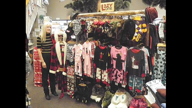 Mary Dockendorf with the display of Lazy One clothing at Minnesota Reflections in the Clearwater Travel Plaza.