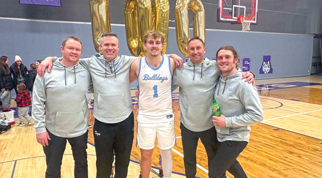 Becker’s Nathan Weiss celebrated his 1,000 career point milestone with his teammates and coaches last week.  He is the first bulldog to reach the career 1,000 point mark in a decade. (Submitted Photo.)