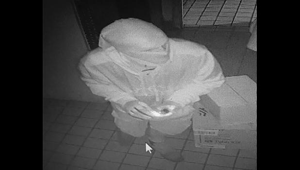 THIS PHOTO (above) came from the surveillance tape at Goodfella’s in Ronneby and identified the thief dressed in white with gloves on and a head scarf. It is believed the same robber is responsible for the break-ins in Ronneby and Santiago.(Submitted Photo).
