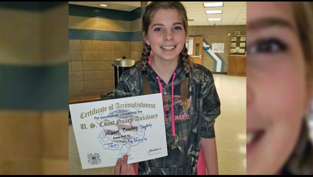 Tori Steffens proudly presents her certificate 