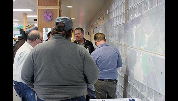 MNDOT PROJECT SUPERVISOR ROBERT ABFALTER (middle, back) used a massive printout hung on the wall at the BCC to explain in detail the road improvement project along Hwy. 10 that concluded last month. (Submitted Photo).
