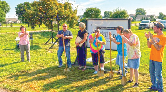 BIG LAKE CHAMBER PRESIDENT Julie Brandt (far left) shot off a confetti cannon to kick off the groundbreaking ceremony for Blackbird Laundry and Apartments. (Submitted Photo).